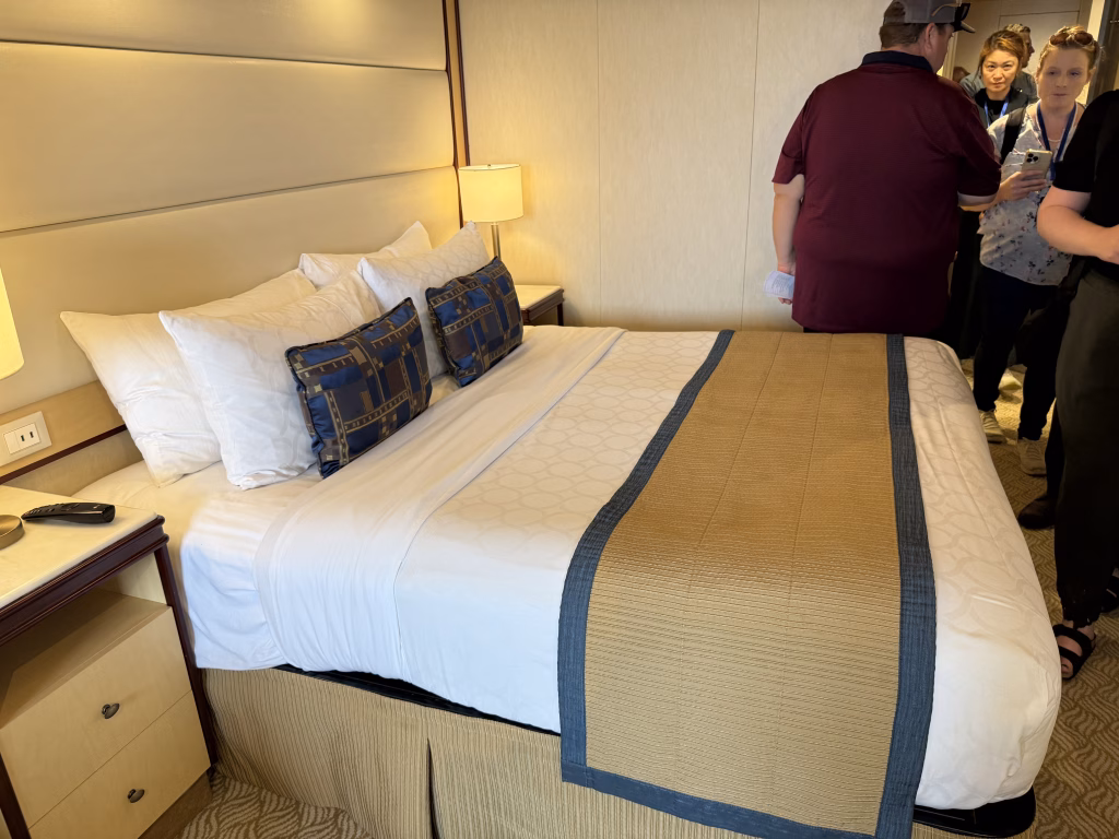 What Is Included in a Cruise Fare? A First-Time Cruiser’s Guide 3 Typical balcony room with the twin beds pushed together to form a queen bed.