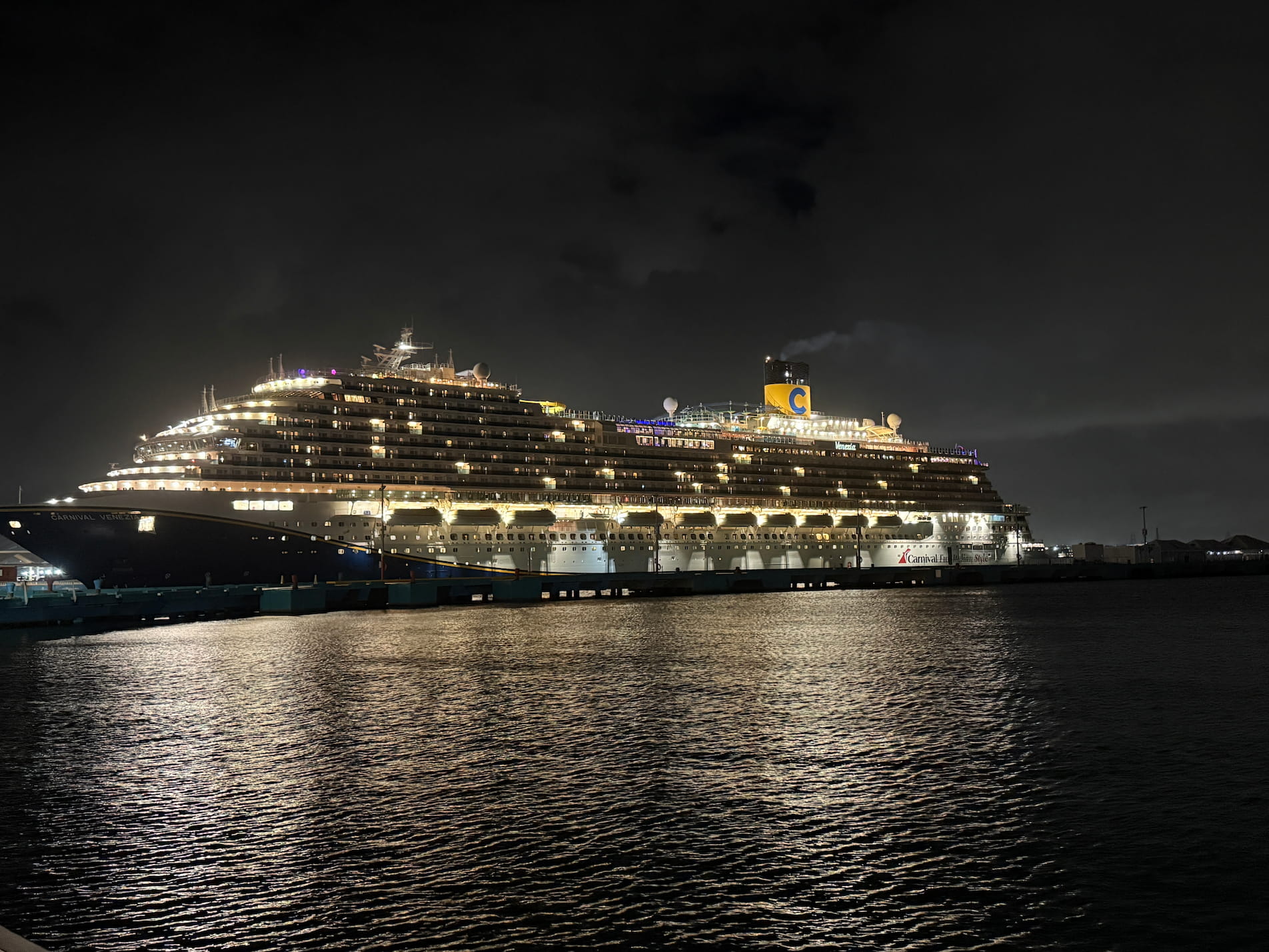 Western vs Eastern Caribbean Cruise: Which Is Better in 2026? 8 San Juan Puerto Rico walking back to the Carnival Venezia at night on Christmas Eve as the ship sits in port with the lights on.